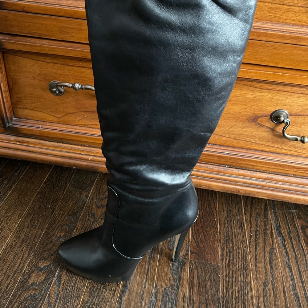 Black leather knee high boots.